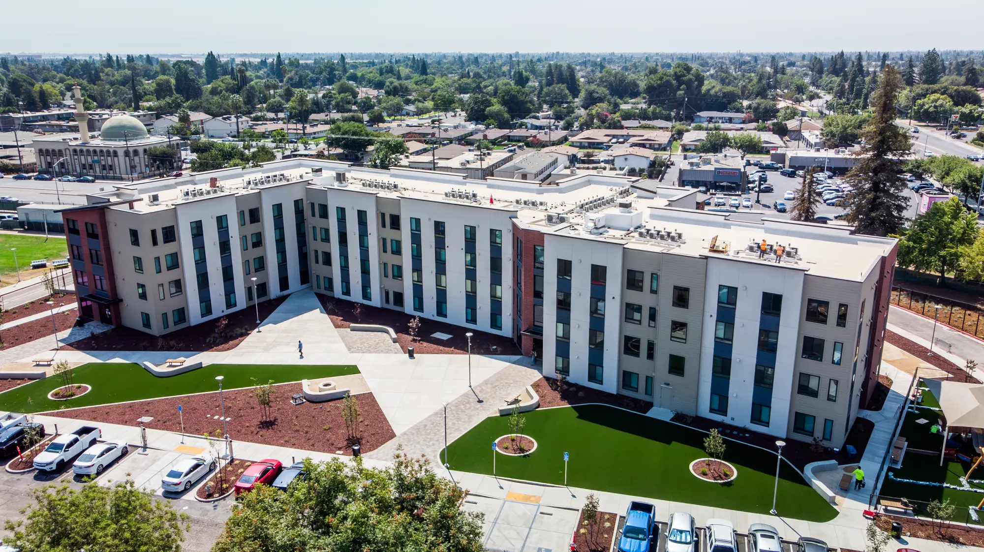 Aerial view of Fresno State campus housing painted white with red brick accents